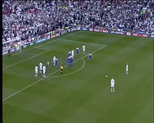 A Soccer Game Is Being Played On A Field With A Large Crowd Watching . GIF