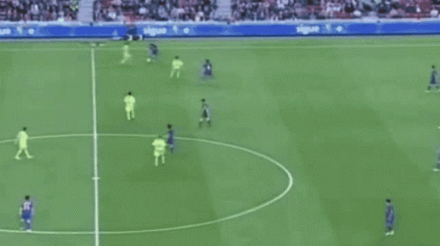 a soccer game is being played on a field with a nike ad behind the goal