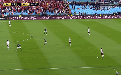 A Soccer Game Is Being Played On A Field With Ads For Qatar Airways And Betfair GIF
