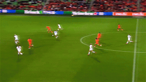 a soccer game is being played on a field with heineken ads on the sidelines