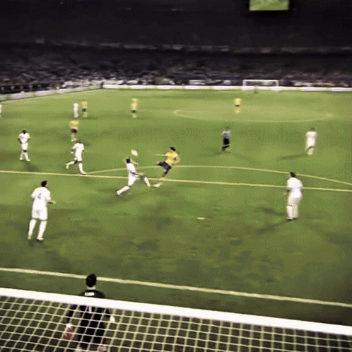 A Soccer Game Is Being Played On A Field With Players In White And Yellow GIF