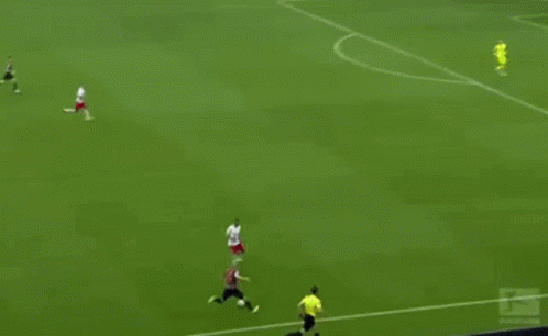 a soccer game is being played on a field with red bull advertisements on the sidelines