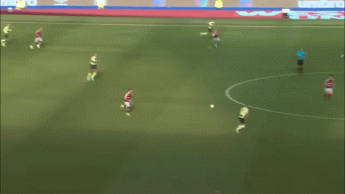 A Soccer Game Is Being Played On A Field With Umbro Ads On The Sidelines GIF
