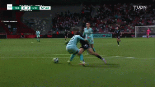 A Soccer Game Is Being Played On A Tv Screen That Says Tudn GIF