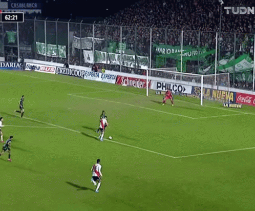 a soccer game is being played with ads for philco and coca cola on the sidelines