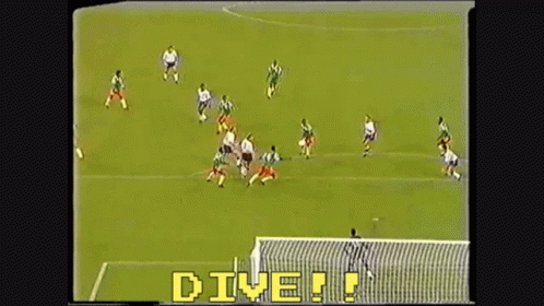 a soccer game is being played with the words " dive " in yellow letters