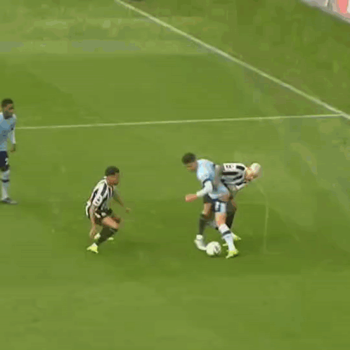A Soccer Game Is Underway And A Goalie Is Diving To Catch A Ball GIF
