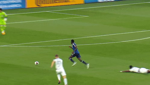 A Soccer Game Is Underway With A Heineken Ad In The Background GIF