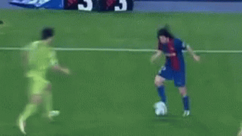 A Soccer Goalie Catches A Soccer Ball That Is Going Into The Net GIF