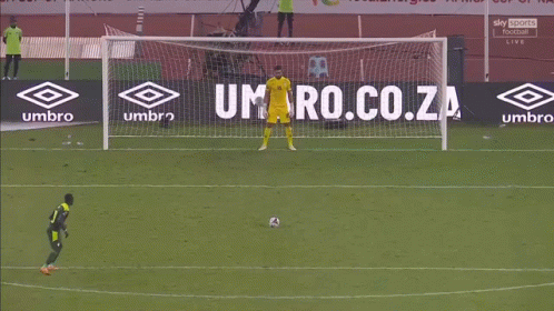 A Soccer Goalie Dives Into The Net During A Game With Sky Sports In The Background GIF
