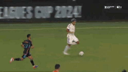 A Soccer Goalie Dives To Catch A Ball In Front Of An At & T Advertisement GIF