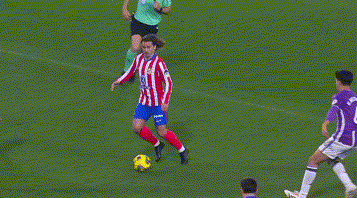 A Soccer Goalie In A Purple Jersey Is Diving To Block A Shot GIF