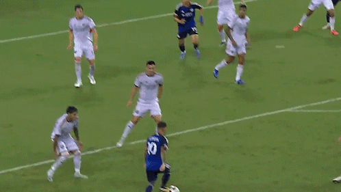 A Soccer Goalie Is Diving To Catch A Ball In Front Of An Adidas Sign GIF