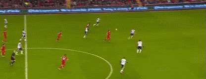A Soccer Goalie Is Jumping In The Air To Catch A Soccer Ball In A Stadium . GIF
