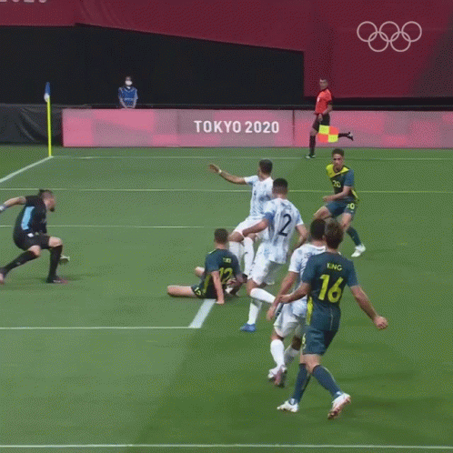 A Soccer Goalie Is Laying On The Field In Front Of A Sign For Fifa GIF