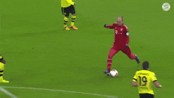 a soccer goalie jumps in the air to catch a soccer ball with the number 21 on it