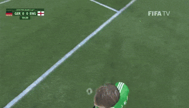 a soccer goalie stands in front of a wall that says fifa