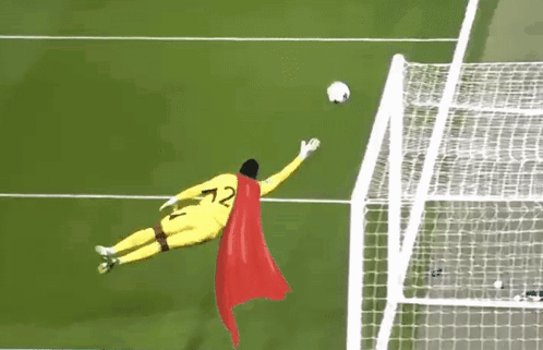 A Soccer Goalie Wearing A Cape And The Number 72 Jumps To Catch A Soccer Ball GIF