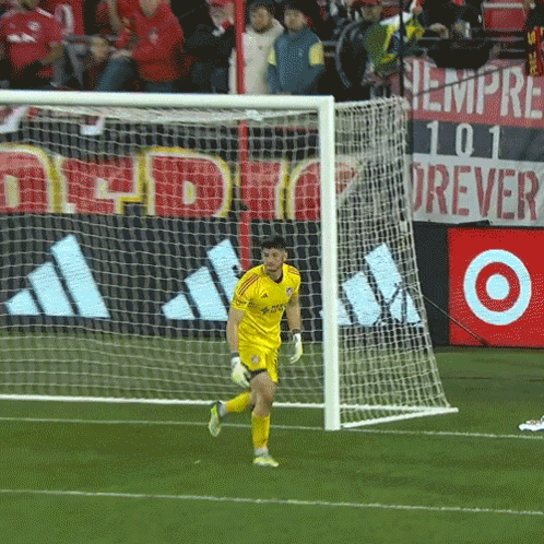 A Soccer Goalie Wearing A Yellow Adidas Jersey Runs Towards The Goal GIF