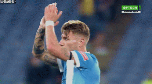 A Soccer Player Applauds In Front Of A Tv Screen That Says Futbol 1 GIF