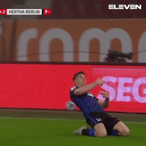 A Soccer Player Celebrates A Goal In Front Of A Screen That Says Hertha Berlin GIF