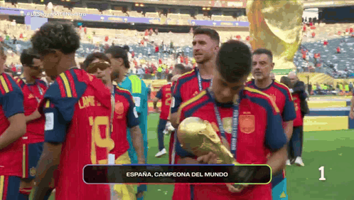 a soccer player holding a trophy that says espana