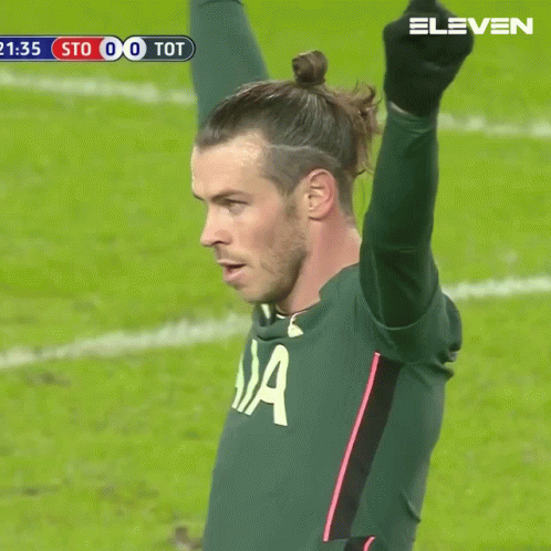 A Soccer Player In A Aia Jersey Holds Up His Arm In The Air GIF