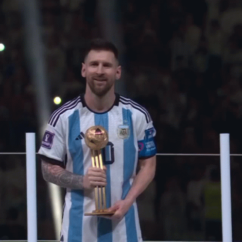 A Soccer Player In A Blue And White Striped Jersey Holds A Trophy GIF