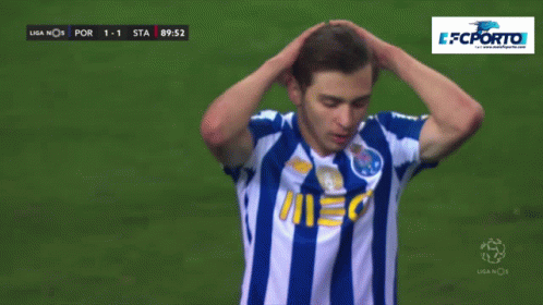 A Soccer Player In A Blue And White Striped Shirt Holds His Hands To His Head GIF