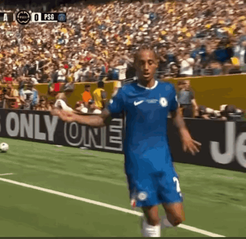 A Soccer Player In A Blue Jersey Stands On A Field In Front Of A Sign That Says " Only One " GIF