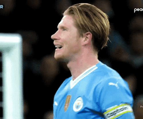 A Soccer Player In A Blue Jersey With The Word Peace On The Bottom Right GIF
