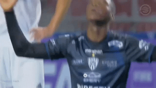 A Soccer Player In A Blue Shirt Is Raising His Arms In The Air GIF