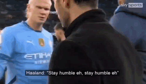 A Soccer Player In A Blue Shirt Is Talking To Another Man In A Black Jacket . GIF