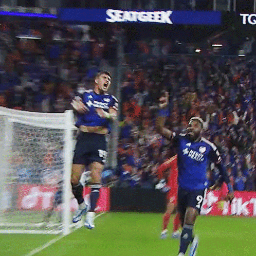 A Soccer Player In A Blue Shirt With The Number 9 On It Jumps In The Air GIF