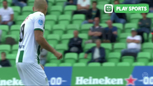 a soccer player in a green and white jersey with the number 9 on his back