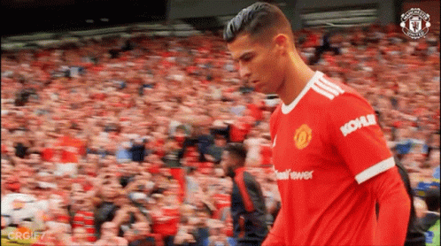 A Soccer Player In A Kohler Jersey Walks In Front Of A Crowd . GIF