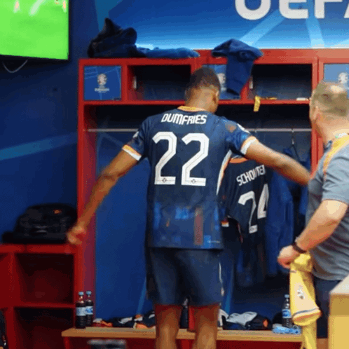A Soccer Player In A Locker Room With The Number 22 On His Jersey GIF