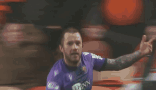A Soccer Player In A Purple Jersey With The Number 23 On It GIF