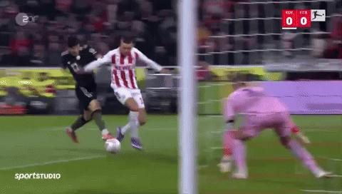 a soccer player in a red and white striped jersey is kicking a soccer ball
