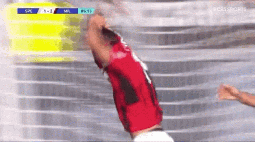 A Soccer Player In A Red Jersey Is Jumping In The Air During A Game . GIF