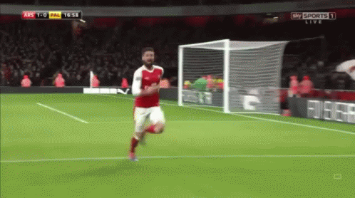 A Soccer Player In A Red Jersey Is Running Towards The Goal GIF