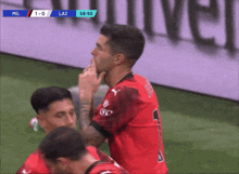 a soccer player in a red jersey with the number 1 on it