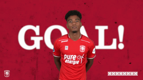 A Soccer Player In A Red Pure Energie Shirt Giving A Thumbs Up GIF