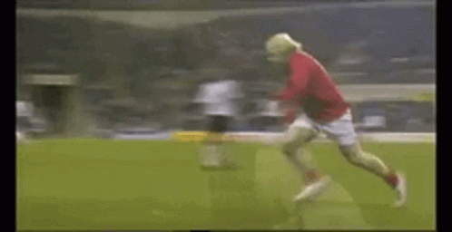 A Soccer Player In A Red Shirt Is Running On The Field GIF