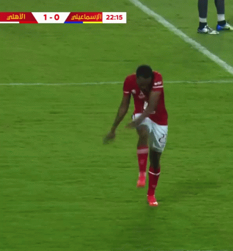 a soccer player in a red shirt with the number 2 on it