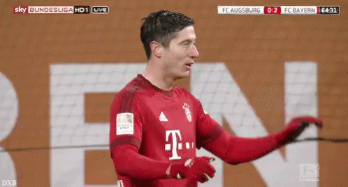 A Soccer Player In A Red T-Mobile Jersey Is Standing In Front Of A Large T-Mobile Sign . GIF