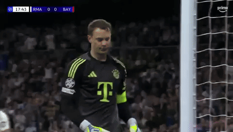 a soccer player in a t-mobile jersey stands in front of the goal