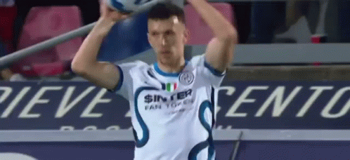 A Soccer Player In A White Shirt Is Holding A Soccer Ball In His Hands . GIF