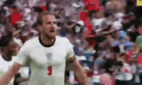 A Soccer Player In A White Shirt With The Number 9 On His Chest Is Standing In Front Of A Crowd . GIF
