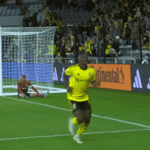 A Soccer Player In A Yellow Adidas Jersey Runs Towards The Goal GIF